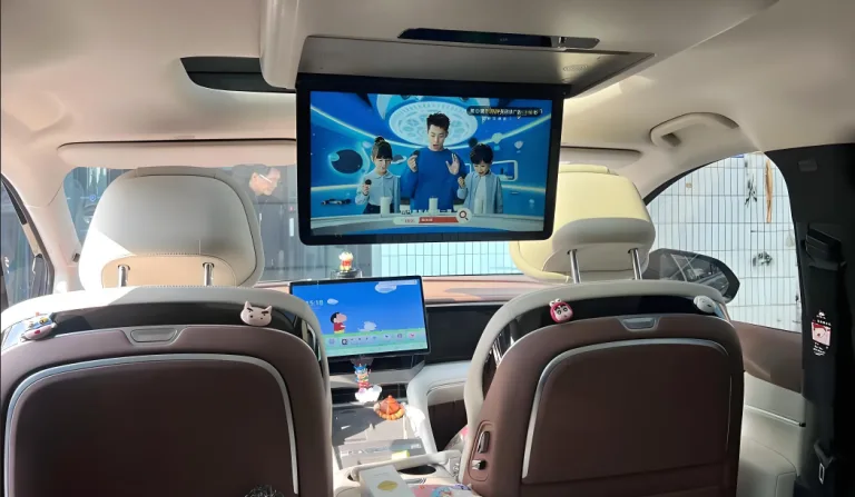 Ultra-thin automotive display with torque hinge for vibration stability in driving conditions.