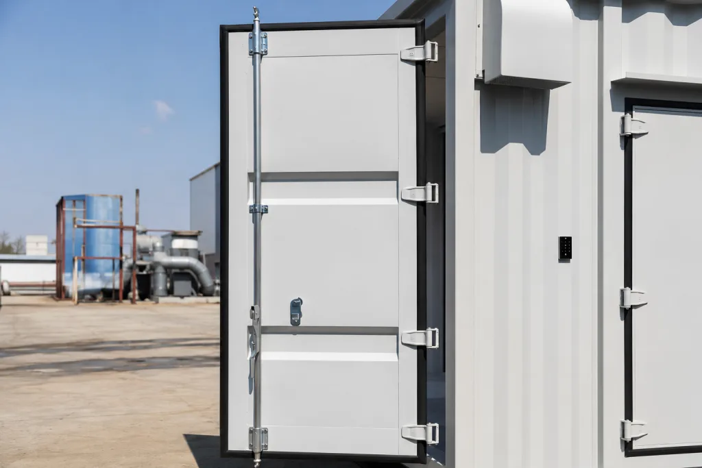 Tall industrial enclosure door supported by multiple discrete external hinges