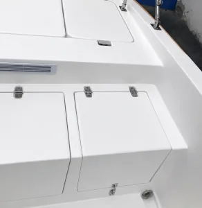Marine enclosure hinges on a boat equipment panel with stainless hardware and outdoor access hatches